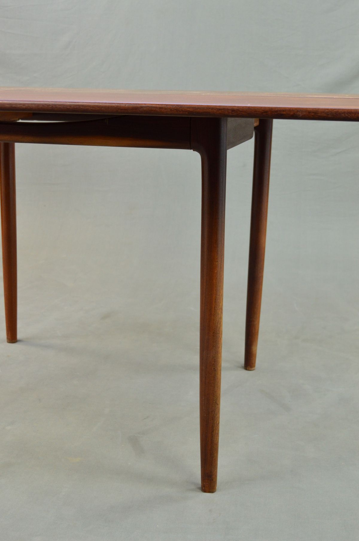 IB KOFOD LARSEN FOR G PLAN, a rectangular teak gate leg table on four cylindrical tapering legs, - Image 5 of 11