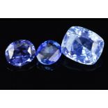 THREE BLUE SAPPHIRES, one cushion cut pale blue, measuring 9.8mm x 8.4mm, weighing 4.30ct, two