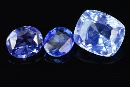 THREE BLUE SAPPHIRES, one cushion cut pale blue, measuring 9.8mm x 8.4mm, weighing 4.30ct, two