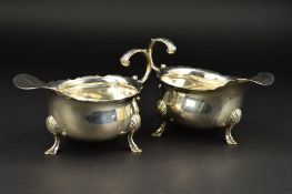 A PAIR OF GEORGE II SILVER SAUCEBOATS, wavy rims, 'S' scroll handles, on three cabriole legs with