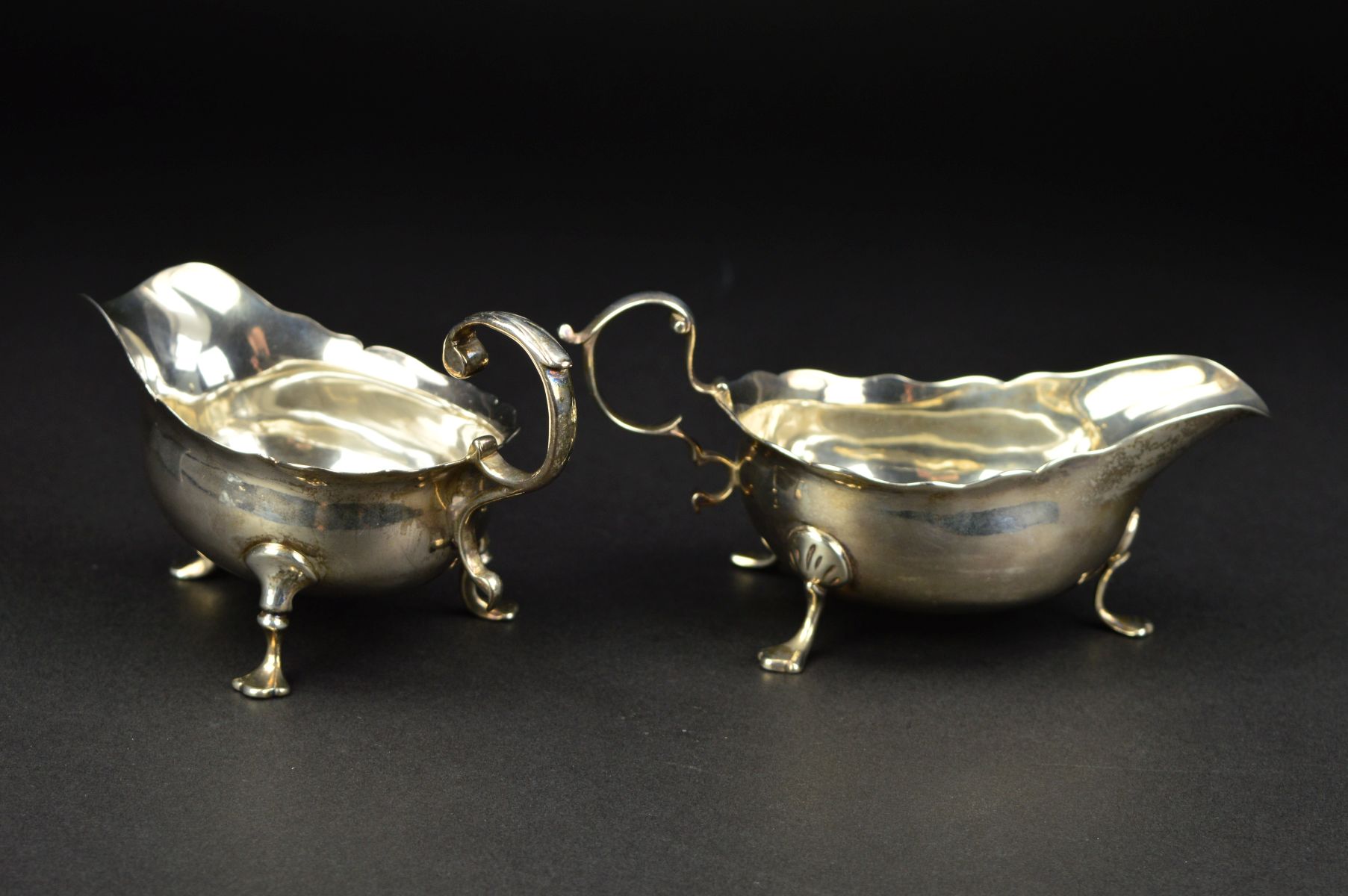 A GEORGE III NEWCASTLE SILVER SAUCEBOAT, wavy rim, 'S' scroll handle, on three cabriole legs with - Image 4 of 10