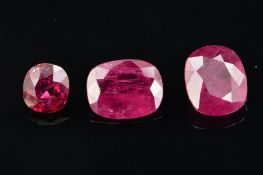 THREE RUBIES, first cushion cut, approximate weight 2.40ct, second cushion cut, approximate weight