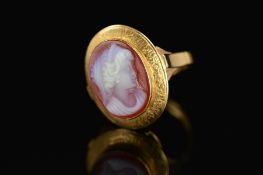 A 19TH CENTURY HARD STONE OVAL CAMEO RING, hard stone cameo depicting a maiden in profile, fitted to