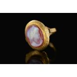 A 19TH CENTURY HARD STONE OVAL CAMEO RING, hard stone cameo depicting a maiden in profile, fitted to