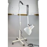 A VINTAGE INDUSTRIAL MOBILE MEDICAL EXAMINATION STANDARD LAMP by Anglepoise on castors