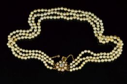 A THREE ROW GRADUATED NATURAL SEAWATER PEARL NECKLACE, measuring approximately 380mm in length,