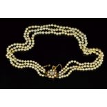 A THREE ROW GRADUATED NATURAL SEAWATER PEARL NECKLACE, measuring approximately 380mm in length,