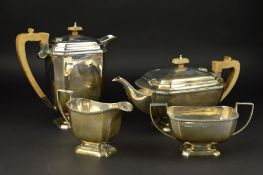 A GEORGE V SILVER FOUR PIECE TEA SERVICE, of rectangular form, cast flower head border, teapot and