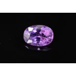 A MAUVE/LAVENDER COLOURED OVAL MIXED CUT SAPPHIRE, measuring approximately 11.5mm x 8mm, weighing