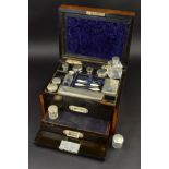 A VICTORIAN BURR WALNUT DRESSING CASE, the hinged cover with brass rectangular cartouche with