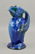 C.H. BRANNAM, an Art Pottery jug modelled as a Grotesque Puffin bird, covered in blue/green
