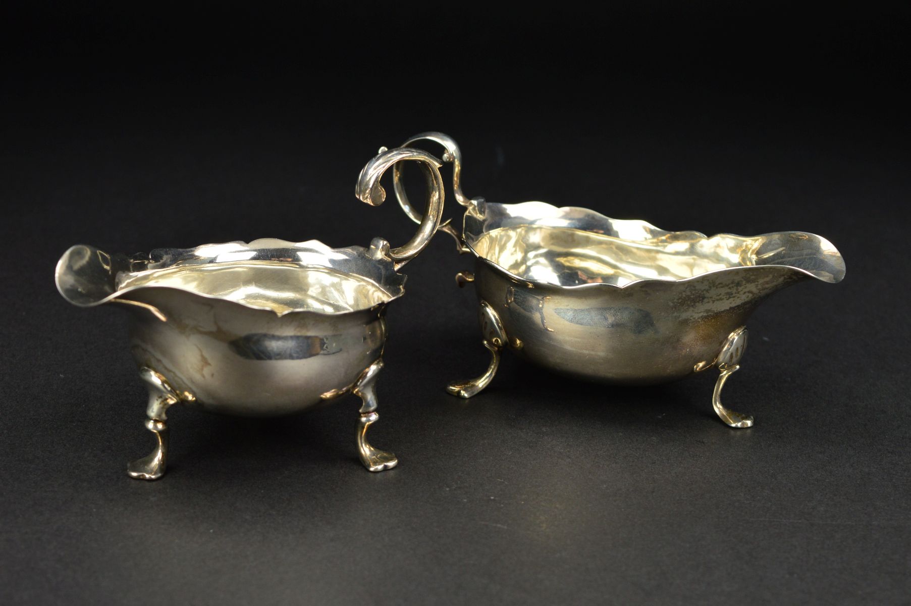 A GEORGE III NEWCASTLE SILVER SAUCEBOAT, wavy rim, 'S' scroll handle, on three cabriole legs with - Image 2 of 10