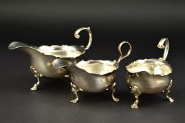 A GEORGE II SILVER SAUCEBOAT, wavy rim, 'S' scroll handle, shell knees above three cabriole legs