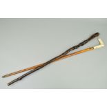 A VICTORIAN MALACCA WALKING STICK WITH BONE HANDLE, the upright section carved with a saddle bag and