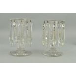 A PAIR OF VICTORIAN CLEAR GLASS LUSTRES, ribbed circular rims suspending ten droppers, on faceted