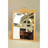 A VICTORIAN RECTANGULAR GILT FRAMED OVERMANTEL MIRROR, surmounted by a central urn on an oval