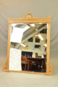 A VICTORIAN RECTANGULAR GILT FRAMED OVERMANTEL MIRROR, surmounted by a central urn on an oval