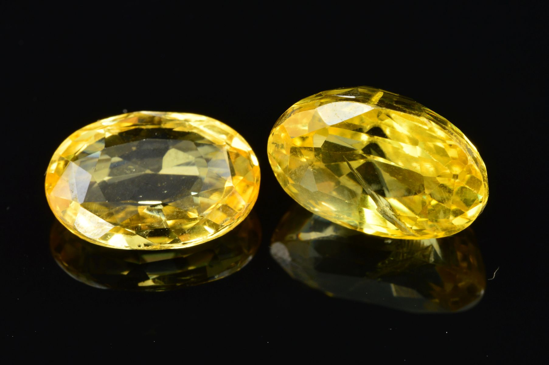 TWO OVAL MIXED CUT YELLOW SAPPHIRES, measuring approximately 12.0mm x 8.5mm, total weight 10.91ct (