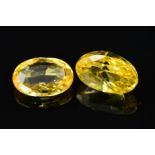 TWO OVAL MIXED CUT YELLOW SAPPHIRES, measuring approximately 12.0mm x 8.5mm, total weight 10.91ct (