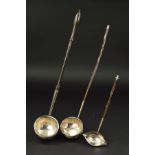 A GEORGE II SILVER PUNCH LADLE, turned wooden handle, the circular bowl repousse decorated with