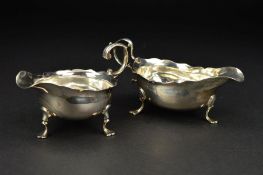 A GEORGE III NEWCASTLE SILVER SAUCEBOAT, wavy rim, 'S' scroll handle, on three cabriole legs with