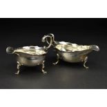 A GEORGE III NEWCASTLE SILVER SAUCEBOAT, wavy rim, 'S' scroll handle, on three cabriole legs with