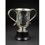 AN EDWARDIAN SILVER TWIN HANDLED TROPHY CUP, 'S' scroll handles with heart shaped terminals, on a