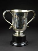 AN EDWARDIAN SILVER TWIN HANDLED TROPHY CUP, 'S' scroll handles with heart shaped terminals, on a