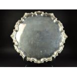 AN ELIZABETH II CIRCULAR SILVER SALVER, the pie crust border cast with a border of foliate shell