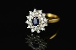 A MODERN SAPPHIRE AND DIAMOND OVAL CLUSTER RING, centring an oval mixed cut dark sapphire