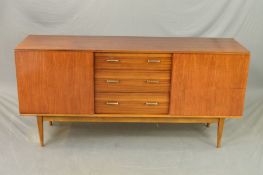 A WRIGHTON 1960’S TEAK SIDEBOARD, flanked by single cupboard doors and three long central drawers on