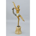 AN ART DECO SPELTER FIGURE OF A DANCER DISROBING, having a gold and silver patina, mounted atop an