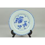 A CHINESE PORCELAIN PLATE, decorated with peony sprays in underglaze blue, lattice pattern border to