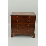 A GEORGE III OAK MINIATURE CHEST OF DRAWERS, two short over three long graduated, with metal knob