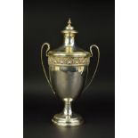 A GEORGE V TWIN HANDLED TROPHY CUP AND COVER, knopped finial over domed cover, the cup with cast rim