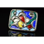 A NORWEGIAN ENAMEL BROOCH BY OYSTEIN BALLE, of rectangular outline with embossed scrolling and