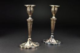 A PAIR OF ELIZABETH II SILVER CANDLESTICKS, of wavy oval outline, detachable sconces, tapering stems