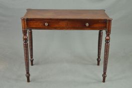 A REGENCY MAHOGANY SIDE TABLE, the rectangular top with rounded corners above two drawers, on four