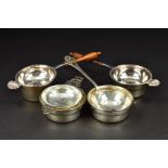 FOUR ELIZABETH II SILVER TEA STRAINERS AND STANDS, two on turned wooden handles with cast shell rest