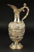 A VICTORIAN SILVER CELLINI PATTERN CLARET JUG, chased and embossed with masks and animals, the