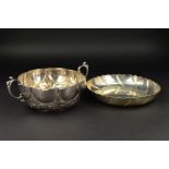 A MID 18TH CENTURY STYLE SILVER TWIN HANDLED BOWL, of lobed circular form, repousse decorated with