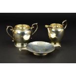 A GEORGE V SILVER CREAM JUG AND MATCHING TWIN HANDLED SUGAR BOWL, cast rims, makers Charles S. Green