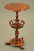 A VICTORIAN WALNUT WINE TABLE, the circular top on a baluster and turned pedestal with circular