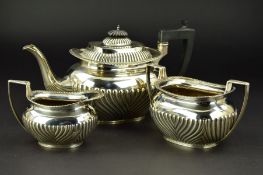 A LATE VICTORIAN SILVER THREE PIECE TEA SERVICE, of oval form, gadrooned rims, reeded decoration,