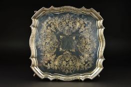 A GEORGE VI SILVER SALVER, of wavy square form, pie crust border foliate engraved decoration, on