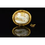 A MID VICTORIAN GOLD MEMORIAL CAMEO BROOCH, oval shell cameo depicting a winged cherub in a