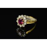 A LATE 20TH CENTURY 18CT GOLD RUBY AND DIAMOND OVAL CLUSTER RING, centring on an oval mixed cut ruby