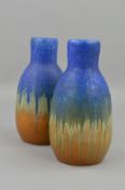 A PAIR OF RUSKIN A9 SHAPED VASES, with a matt blue glaze over a gloss orange, impressed Ruskin