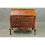 A 18TH CENTURY OAK BUREAU, the fall front with reading ledge opening to reveal a mahogany and inlaid