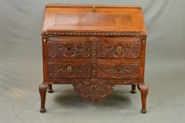 A 18TH CENTURY OAK BUREAU, the fall front with reading ledge opening to reveal a mahogany and inlaid